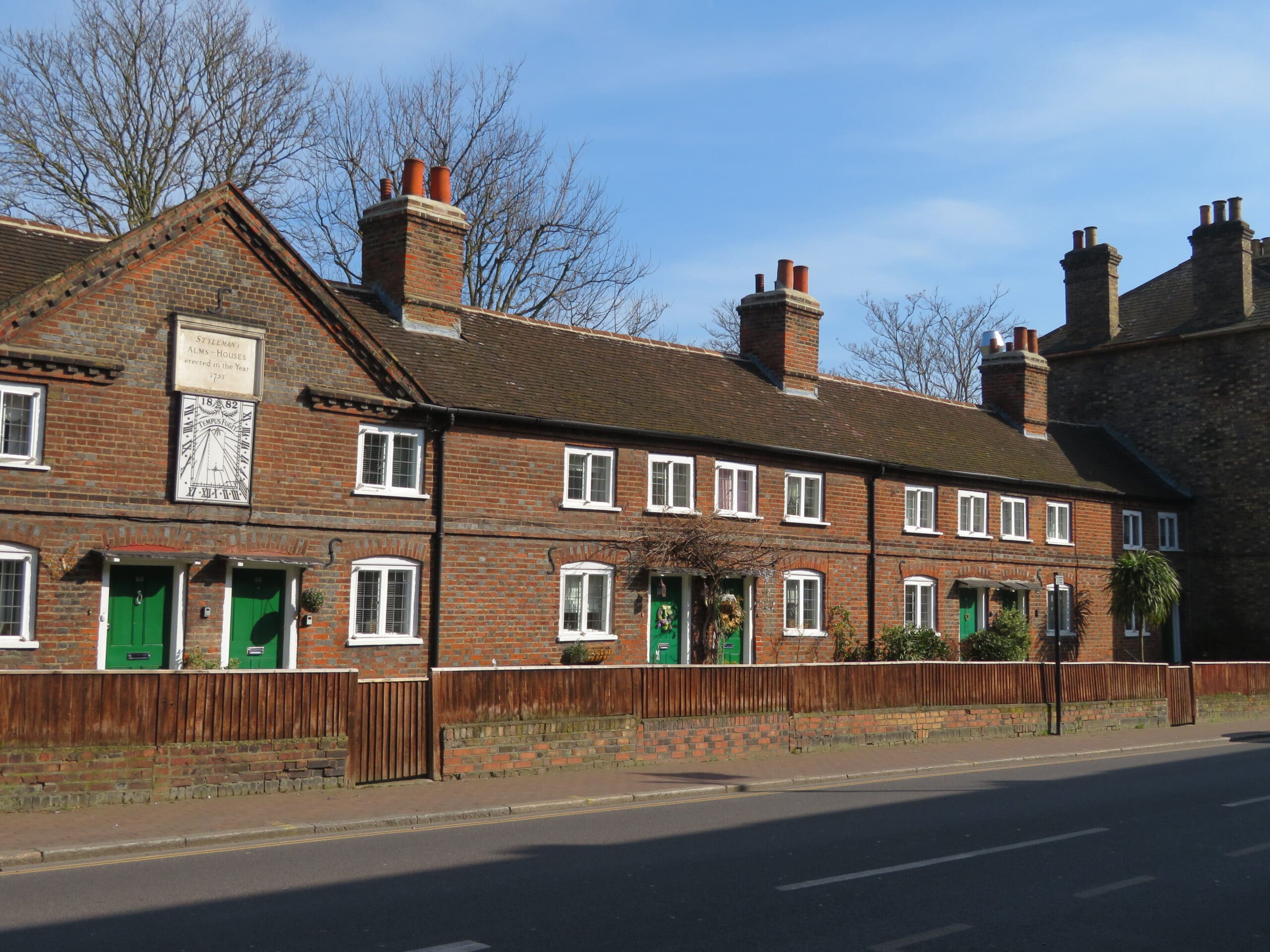 from of almshouses with green doors