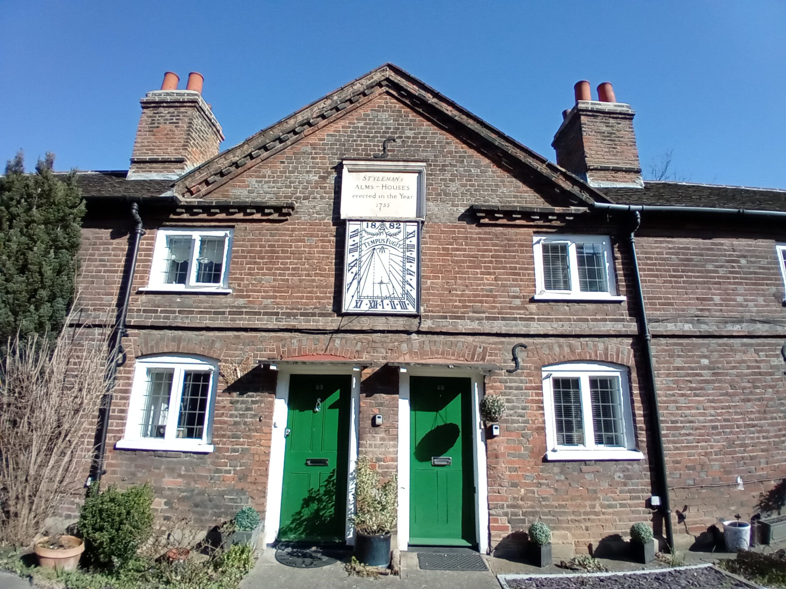 front of almshouses with green doors